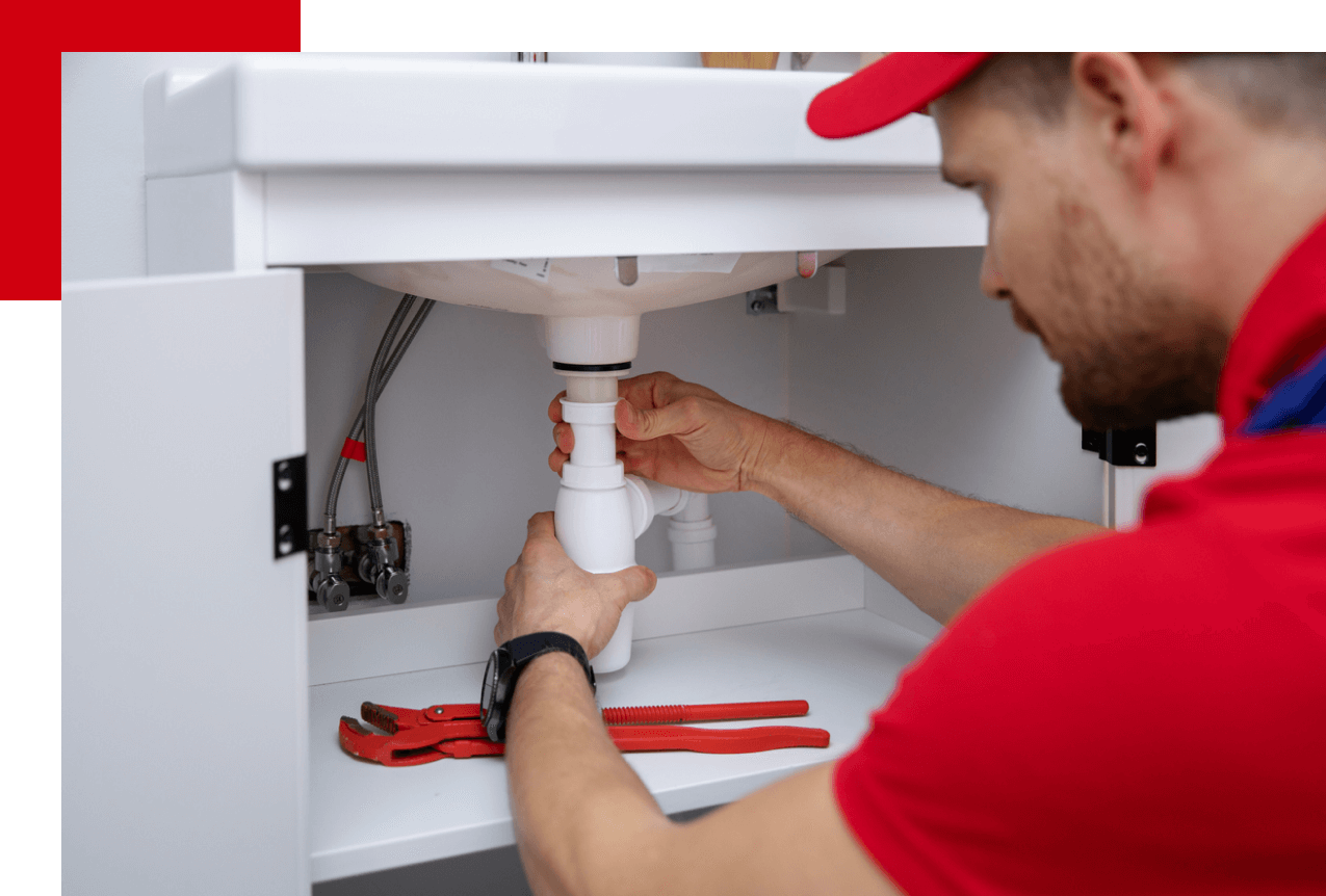 Red plumber fixing sink