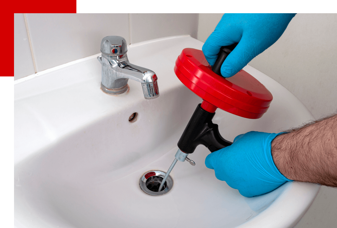 plumber snaking a sink plug